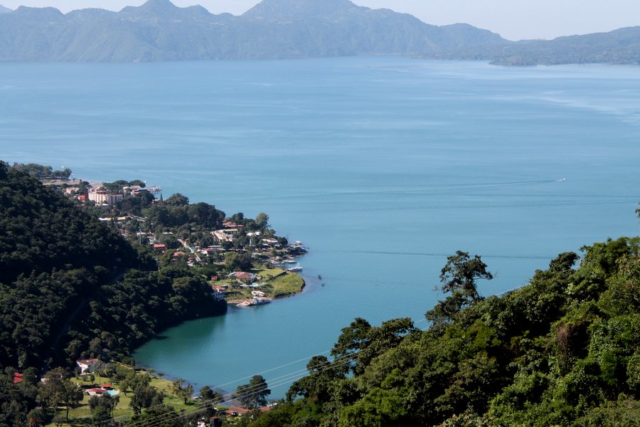 The blue water of Lake Atitlan meets the green volcanic slopes 