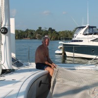 Our boat neighbor, Michel, patching up a net.
