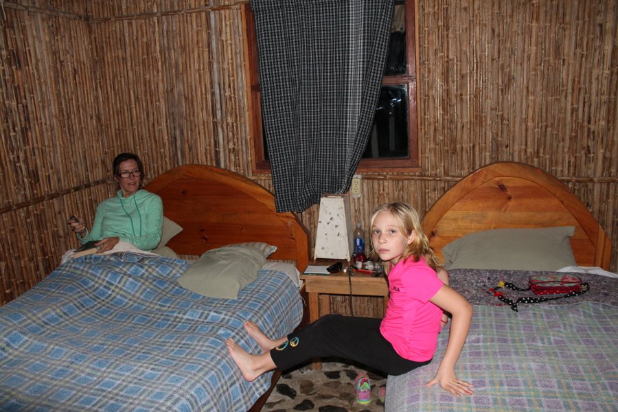 Our little room with cane walls and river rock flooring. I don't know what is in my hand but it is for-sure not a remote. 