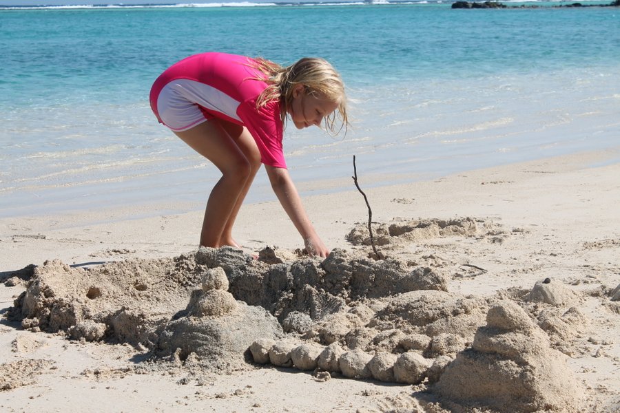 Sand castle city had a central lagoon where a small conch was entrapped and played with between construction projects.