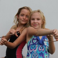 Fern and Lily taking aim at me with their homemade bows.