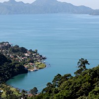 The blue water of Lake Atitlan meets the green volcanic slopes 